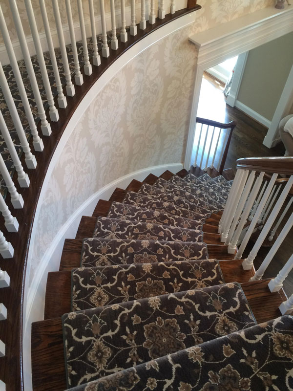 Beautiful Curved Staircase with Patterned Grey and White Stair Runner