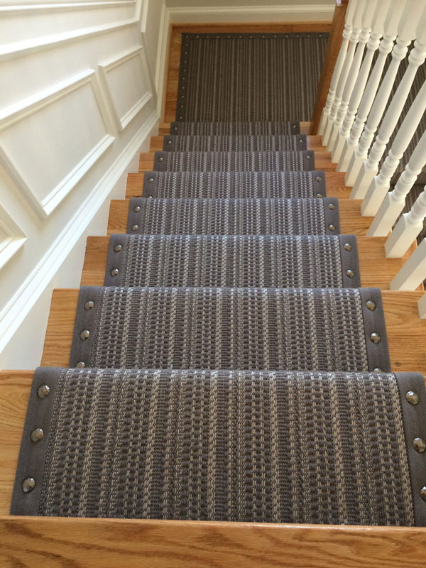 Looking down at Striped Gray Carpet with Rivet Edging