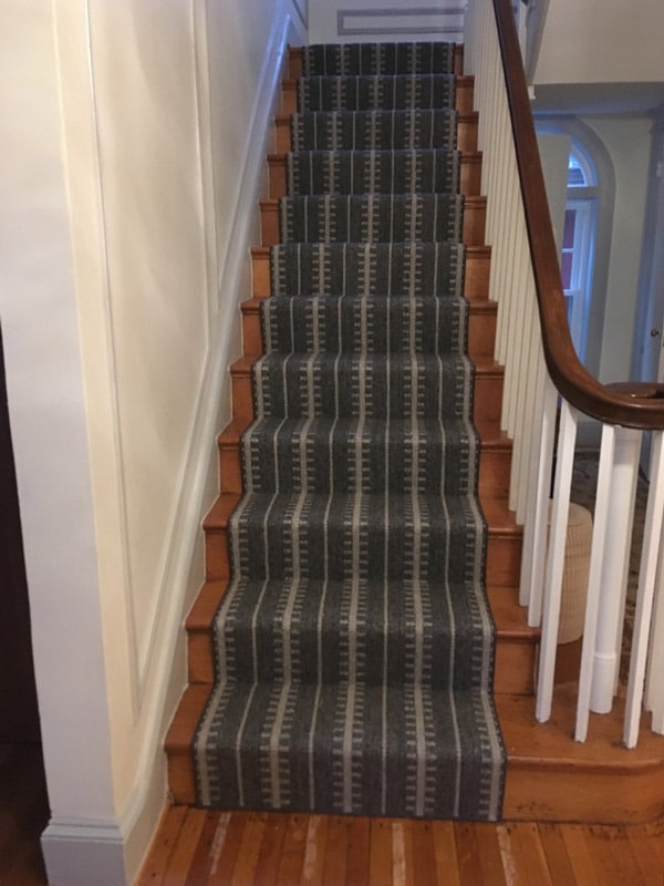 Dark Striped Carpet Runner on Hardwood Staircase